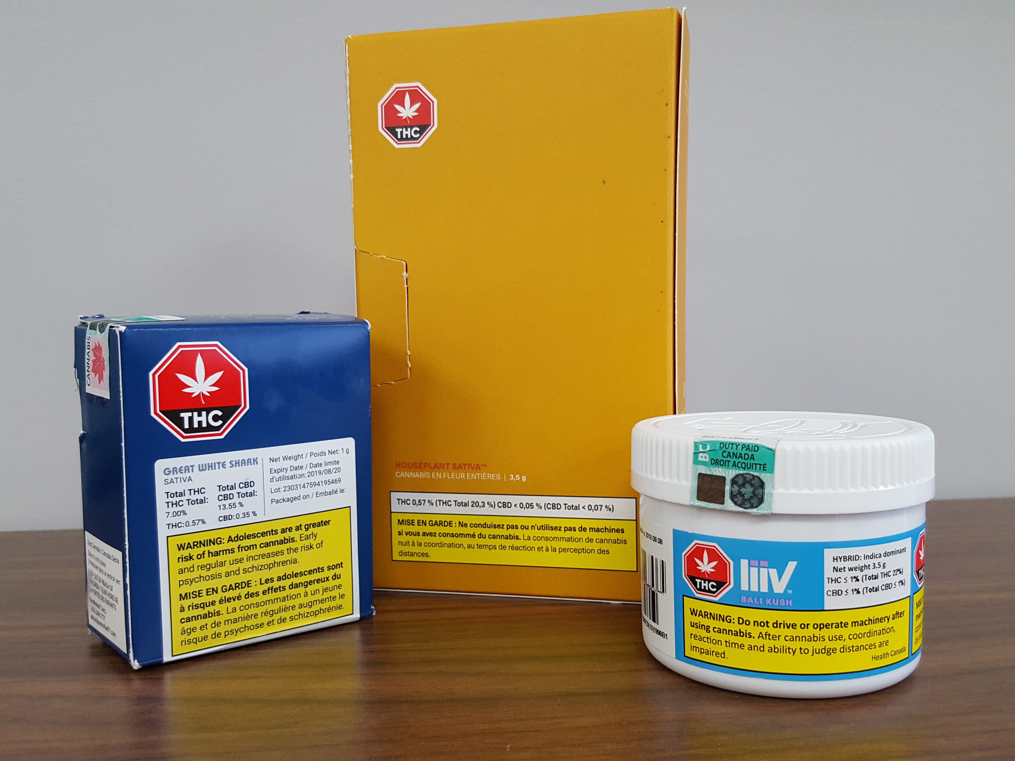 Three legal marijuana products are neatly arranged on table