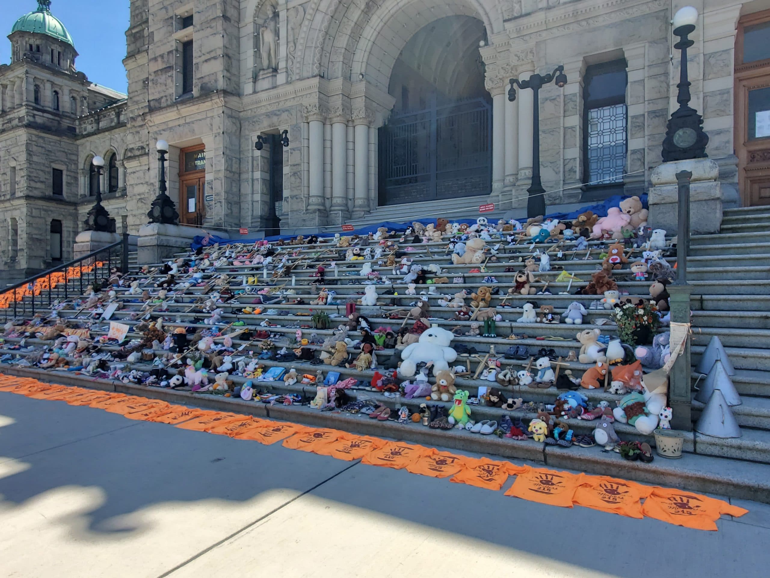 Childrens shoes and teddy bears on the steps of the Legislature in Victoria, BC